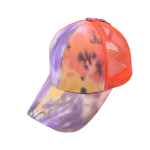 Detail of colorful tie-dye baseball cap with orange mesh back and curved brim