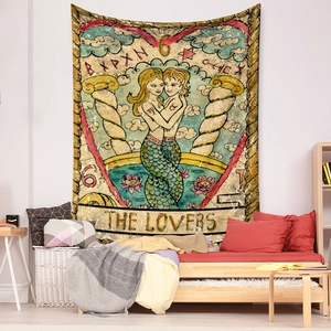 Detail of bohemian The Lovers tarot card tapestry hanging on a cozy bedroom wall