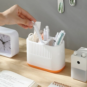 Modern white and orange desk pencil holder with three compartments and vertical stripes