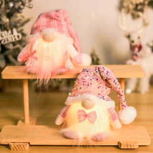 Close-up of glowing pink sequin Christmas gnomes decorations on a wooden stand