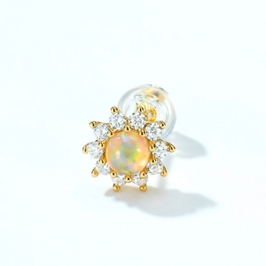Minimalist gold star stud earring with a round opal center and zircon halo on white background