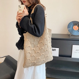 Detailed look at the beige hollow knit tote bag showing diamond weave texture