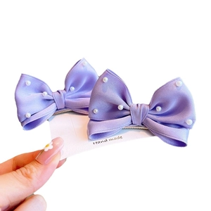 Pair of purple satin bow hair clips with white pearls for girls on handmade display card
