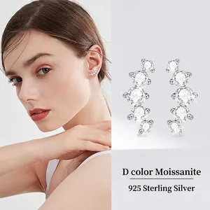 Moissanite curved five-stone stud earrings in 925 sterling silver on model and closeup