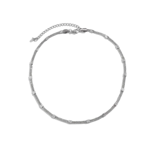 Detail of silver double-layered chain necklace with textured square metal accents and clasp