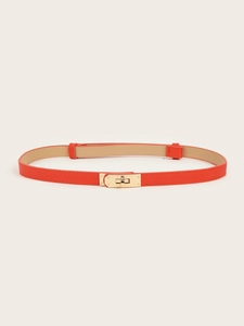 Detail of red thin leather belt featuring a classic gold-tone metal twist lock buckle