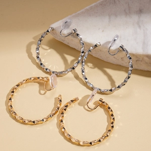 Minimalist twisted geometric hoop clip-on earrings in polished gold and silver metal