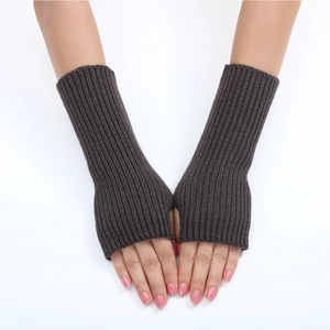Close-up of dark grey knitted fingerless gloves with a soft ribbed texture on hands