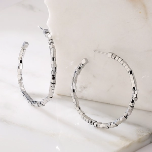 Silver geometric cube bead hoop earrings in a minimalist metallic ring design