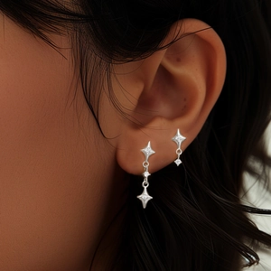 Close-up of S925 silver star tassel earrings with zircon stones on a female model