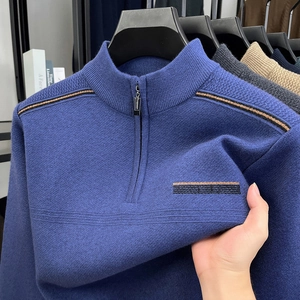 Detail of blue men's quarter-zip knit sweater showing high elasticity and ribbed texture