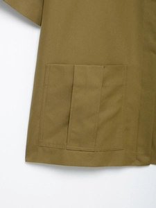 Detail of cargo pocket with central pleat on khaki cotton twill shirt fabric
