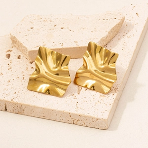 Irregular wrinkled 18k gold plated 304 stainless steel earrings on stone display