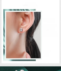 Detail of s925 silver stud earrings with oval zircon in a minimalist bezel setting