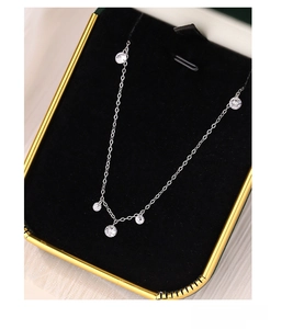 Macro shot of S925 silver necklace with sparkling cubic zirconia charms in a gift box