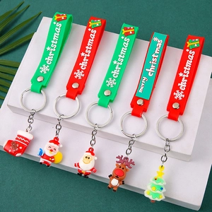 Festive Christmas silicone keychains with Santa and Reindeer charms on a green background