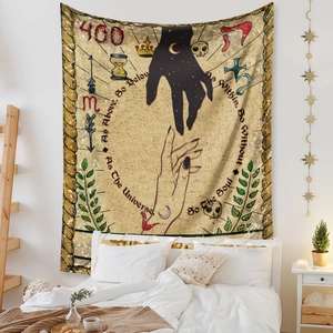 Detail of bohemian tapestry featuring mystical hands and celestial quotes in a bedroom