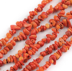 Macro detail of irregular orange coral beads for DIY jewelry making and shell crafting