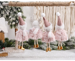 Detail of pink and gold Christmas plush ornaments hanging on a wooden rope branch