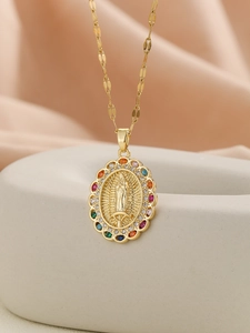 Close-up of gold Virgin Mary pendant featuring a halo of colorful micro-set zircons