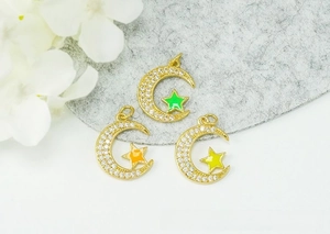 Detailed view of 18K gold plated crescent moon and colorful oil-dripping star pendants