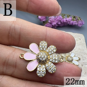 Macro detail of 22mm pink enamel daisy charm with cubic zirconia for jewelry making