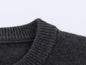 Women's dark gray crew neck knit sweater with premium wool texture and ribbed neckline