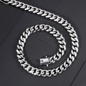 Detail of silver Cuban link chain showing the secure box clasp and polished steel finish