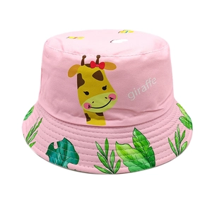 Detail view of pink kids bucket hat with cute giraffe and tropical leaf print pattern