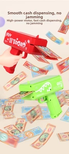 Close-up of electric money gun with high-power motor and flying toy banknotes