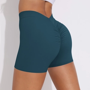 Close-up of high-waist V-cut scrunch booty yoga shorts in deep teal with elastic fabric