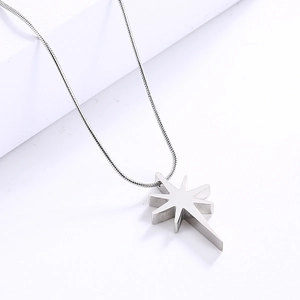 Detailed top view of silver star pendant necklace with cubic zirconia on white background