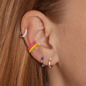 Close-up of model wearing colorful enamel bamboo hoop earrings with zircon accents
