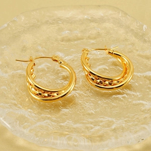 Minimalist multi-layer gold C-shaped earrings with textured twisted metal detail