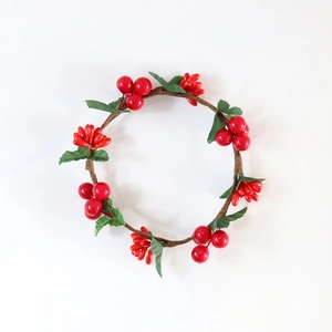 Detail showing the red berry wreath with green leaves and realistic vine texture