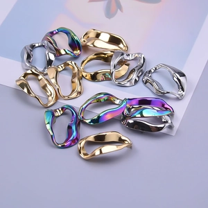 Detail of wavy oval 304 stainless steel pendants in gold, silver, and rainbow finishes