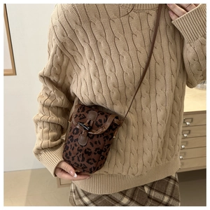 Vertical leopard print crossbody phone bag shown with autumn outfit on a model