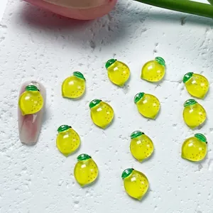 3D realistic resin lemon nail charms with glitter detail on white stone texture