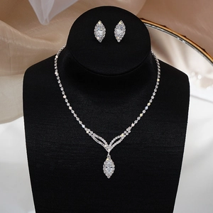 Detail of bridal jewelry set with marquise-cut zircon fringe necklace and earrings