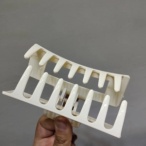 Close-up of a large cream-colored hair claw clip with a strong resin grip design