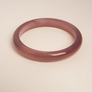 Detailed view of lavender translucent cat eye stone bracelet with smooth polished finish