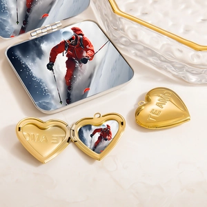 Macro view of gold heart locket necklace pendant with custom skiing photo and Te Amo engraving