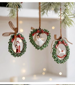 Detailed view of resin Christmas ornaments featuring Santa, Angel and Rocking Horse on wreaths