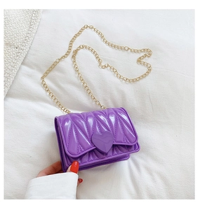 Detail of purple silicone heart purse featuring 3D diamond texture and gold metal chain