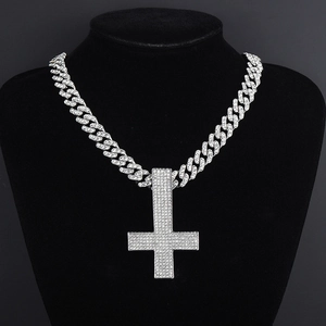 Hip hop silver Cuban link necklace with iced out inverted cross pendant on black bust