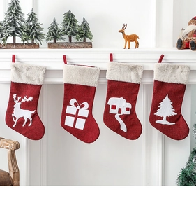 Set of 4 plush red Christmas stockings with white fur trim hanging on a fireplace mantel