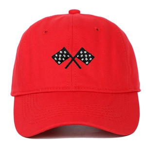 Close-up of red cotton baseball cap featuring racing flag embroidery and twill texture