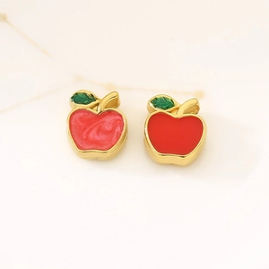 Red enamel apple charms in stainless steel with gold finish and green leaf details