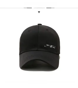 Detailed view of black cotton baseball cap showing silver geometric embroidery and stitching