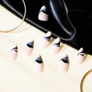 Pink press-on nails with ink wave abstract patterns in almond shape on beige background
